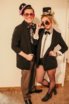 two people dressed up in costumes posing for the camera