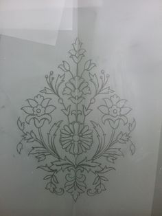 an intricately designed piece of glass with flowers on it