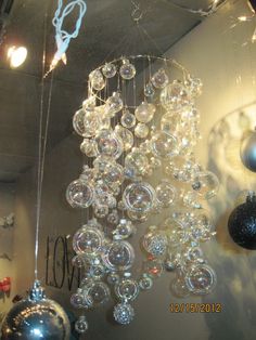 a chandelier hanging from the ceiling in front of a wall with christmas decorations