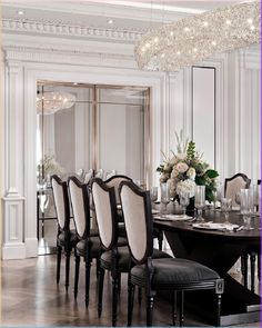 a dining room table with chairs and a chandelier