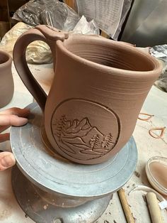 two mugs are sitting on top of each other in the process of being made