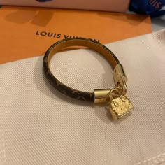 It Was Bought On June 2021 In Miami Lv Flagship. Never Worn Once. It Is In Size 15 ( The Length Is Depicted In The Picture). It Comes With A In Store Purchase Receipt, A Pocket, A Box. A Delicate And Intensely Feminine Bracelet, Adorned With A Charm Evoking The Maison's Iconic Alma Bag. Available In Monogram Canvas And Epi Leather Versions, The Strap Is Rounded On Top And Flat Against The Wrist For Added Comfort. 5.9 Inches (Length) Monogram Canvas Strap With Calf Leather Lining Brass With Shiny Lv Jewelry Bracelet, Lv Leather Bracelet, Lv Bracelet Women, Body Candy Jewelry, Lv Bracelet, Loui Vuitton, Feminine Bracelet, Pandora Bracelet Charms Ideas, Louis Vuitton Bracelet