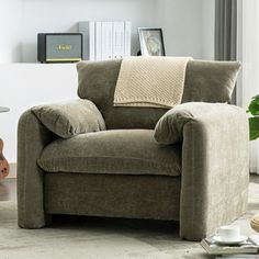 a living room with a brown chair and coffee table