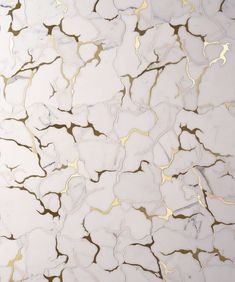 an abstract marble pattern with gold and white highlights on the top, as well as some black