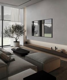 a living room with large windows and a tree in the corner on the far wall