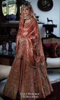 a woman in a red and gold bridal gown