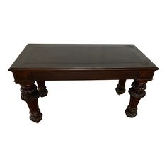 a wooden table with carved legs on an isolated white background for use as a coffee table