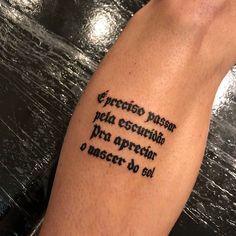 a person with a tattoo on their arm that has words written in spanish and english