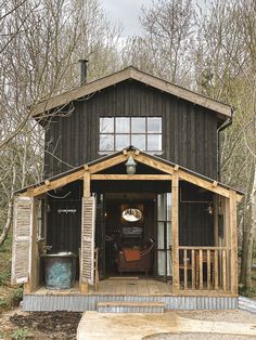 a wooden building with a porch and stairs