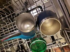 pots and pans are sitting in the bottom rack of a dishwasher,