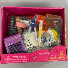 a pink box filled with assorted school supplies and writing utensils in it