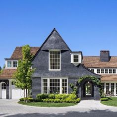 a large gray house with white trim and windows