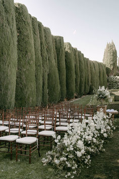 rows of chairs lined up next to each other in front of an outdoor ceremony area