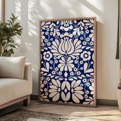 a blue and white floral design on a wooden frame