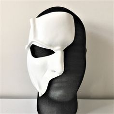 a black and white mask is on display