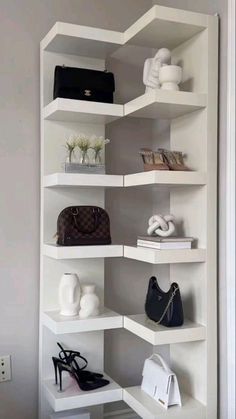 a white shelf filled with purses and handbags