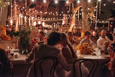 a group of people sitting around a dinner table