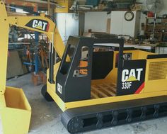 a yellow and black machine in a garage