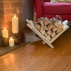 a pile of wood sitting on top of a wooden floor next to a fire place