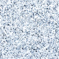 a white and blue speckled surface with small black dots on the bottom half of it