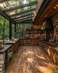 an outdoor kitchen with wood floors and glass walls