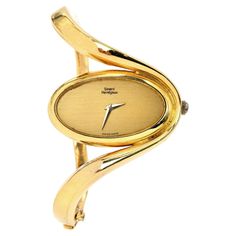 This Vintage 1980s Girard 6 solid gold bangle watch. This collectible Vintage piece is crafted in highly polished 18K Yellow Gold, weighing 77.0 grams and measuring: 6” around the wrist. An inversed oval, wave bangle watch, with a unique and elegant look. The inner movement is Chopard brand. Secured with a hinged insert clasp. Hallmarked & Numbered: 51383 and 5047-1 Measurement In excellent condition This purchase is accompanied by a professional appraisal document. Collectible Vintage Yellow Gold Jewelry And Watches, Gold Bangle Watch, Retro Gold Collectible Watches, Luxury Vintage Yellow Bracelets, Girard Perregaux Watches, Solid Gold Bangle, Antique Self-winding Yellow Gold Watch, Bangle Watches, Chanel Perfume