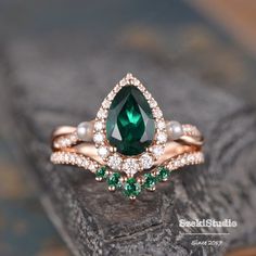 "Emerald Engagement Ring Set Rose Gold Pear Shaped Lab Emerald Bridal Set Halo Infinity Diamond Wedding Set Jewelry 2 Ring Set May Birthstone ITEM INFORMATION Metal Type - Solid 14k Rose Gold Band Width - (approx. 2.2mm) Engagement ring: Center Stone - 6x9mm Lab emerald, Pear Shaped Side Stone - Akoya Pearl & Lab Emerald Size- 2.5-1.6mm Side Stone - Natural Diamond, H color, SI clarity/Moissanite, D color, VVS clarity Weight - 0.57ct **Stone Replacement** Available with any other gemstones, Green Engagement Rings, Emerald Engagement Ring Green, Emerald Engagement Ring Set, Emerald Wedding Rings, Emerald Wedding, Diamond Wedding Sets, Set Jewelry, Dream Engagement Rings, May Birthstone