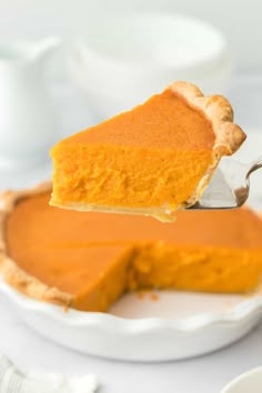 a slice of pumpkin pie being lifted with a fork