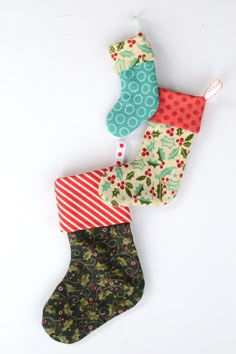 three christmas stockings hanging on a white wall