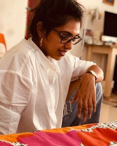 a woman sitting on the floor looking at something