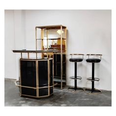 three black and gold bar stools next to each other