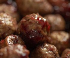 the meatballs are covered with cranberry sauce and have been cooked in the oven