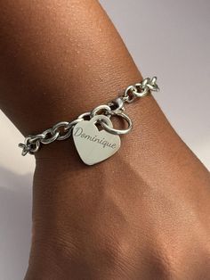 Delight in the timeless elegance of the Personalized Stainless Steel Heart Bracelet, a perfect accessory for any occasion. Constructed from 316L Surgical Grade Stainless Steel, this bracelet is designed to withstand daily wear without tarnishing or causing skin discoloration. It is water-resistant, making it ideal for wearing in the shower or pool. Available in 7-inch and 8-inch lengths and measuring 1/4 inch wide (7mm), it ensures a comfortable fit for everyone. Features: Material: Made from 316L Surgical Grade Stainless Steel that won't tarnish or turn skin green, ensuring long-lasting wear and durability. Lengths: Available in 7-inch and 8-inch lengths to provide a perfect fit for every wrist. Width: The bracelet measures 1/4 inch wide (7mm), offering a sleek and elegant look. Heart Cha Trendy Stainless Steel Charm Bracelet, Personalized Chain Bracelet As Gift, Personalized Chain Bracelet Gift, Heart Shaped Metal Bracelets For Wedding, Heart-shaped Metal Bracelets For Wedding, Classic Adjustable Bracelets With Heart Charm, Trendy Personalized Silver Bracelet, Classic Adjustable Bracelet With Heart Charm, Elegant Stainless Steel Heart Bangle Bracelet