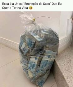 a bag full of money sitting on the ground next to a wall with a plastic bag over it