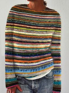 a woman wearing a multi colored striped sweater