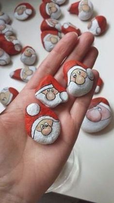 someone is holding up some rocks with santa clause on them