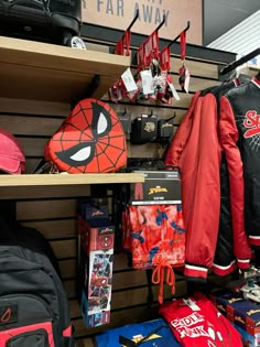 the spiderman jacket is on display in the store with other clothing and backpacks