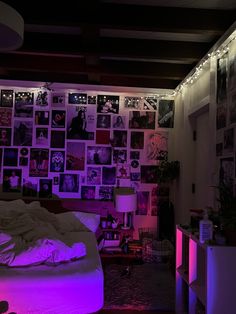 a bedroom with purple lights and pictures on the wall