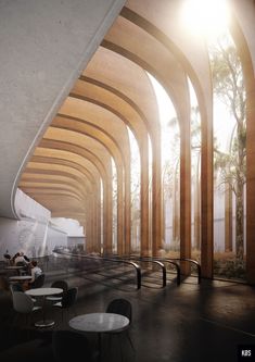 an empty room with tables and chairs in the center, surrounded by tall wooden arches