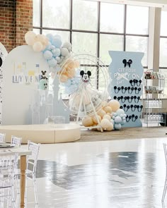 an event with balloons and mickey mouse decorations