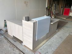 an unfinished office desk in the middle of a building being built with wood veneers