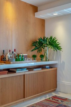 a plant is sitting on top of a counter in a room with wood paneling