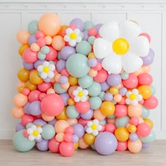 a bunch of balloons that have flowers on them