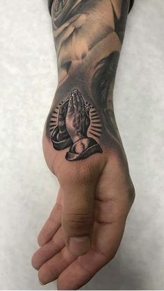 a man's hand with a tattoo on it and an image of a buddha