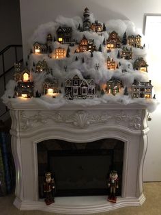 a mantel decorated with christmas decorations and lit candles