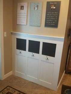 the entryway is decorated in white and has several cubbys on each side