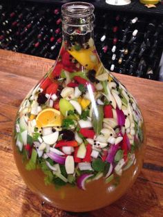 a bottle filled with lots of different types of vegetables