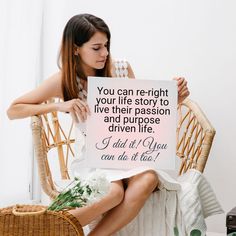 a woman sitting in a chair holding a sign that says you can re - right your life story to live their passion and purpose driven life