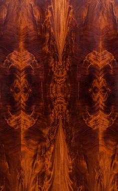 an abstract image of wood grained in brown and orange tones, with two faces on each side