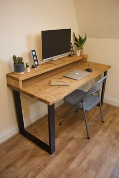 a wooden desk with a computer monitor and keyboard